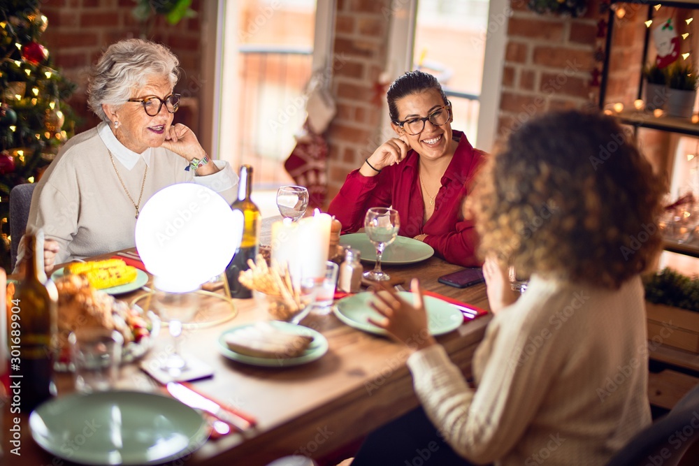 Beautiful group of women smiling happy and confident. Eating roasted turkey celebrating christmas at home Beautiful group of women smiling happy and confident. Eating roasted turkey celebrating christmas at home