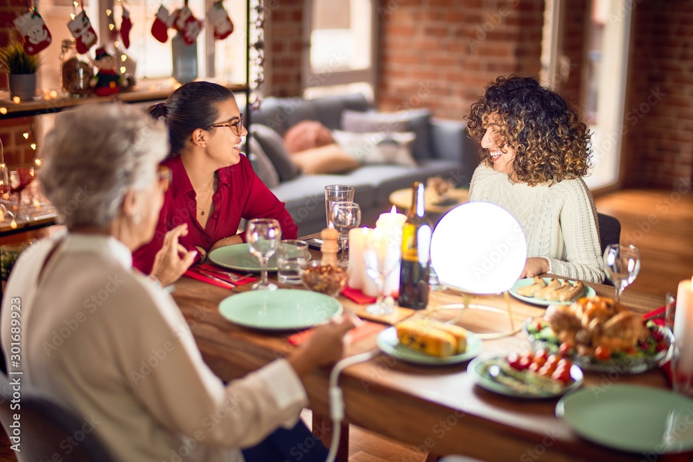 Beautiful group of women smiling happy and confident. Eating roasted turkey celebrating christmas at home Beautiful group of women smiling happy and confident. Eating roasted turkey celebrating christmas at home