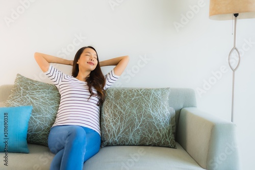 Portrait beautiful young asian woman smile happy on sofa