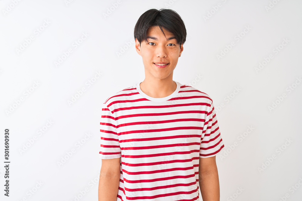 Young chinese man wearing casual striped t-shirt standing over isolated white background with a happy and cool smile on face. Lucky person. Young chinese man wearing casual striped t-shirt standing over isolated white background with a happy and cool smile on face. Lucky person.