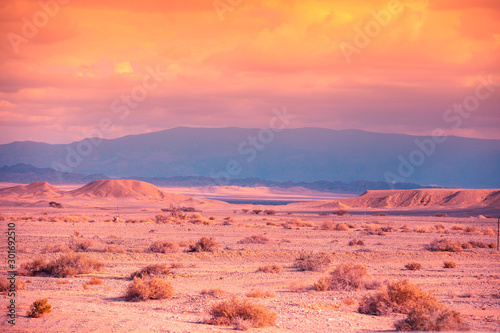 Mountain nature landscape. Desert in the early morning. Beautiful sunrise in the mountains. Desert Arava. View of the valley from the mountain in the background. The nature of Israel