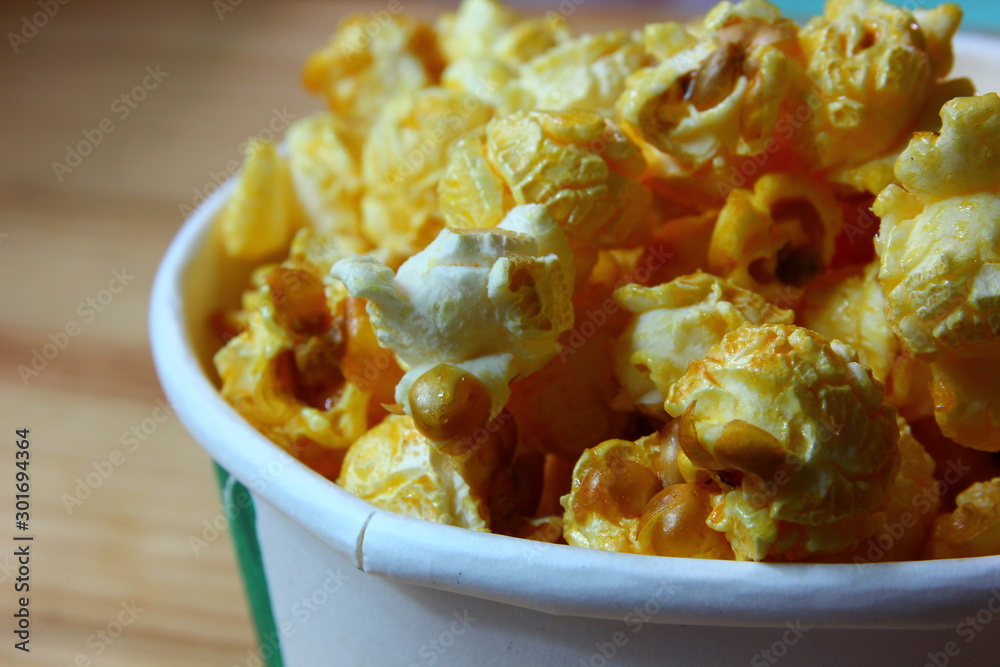close up caramel popcorn in white paper cup close up caramel popcorn in white paper cup