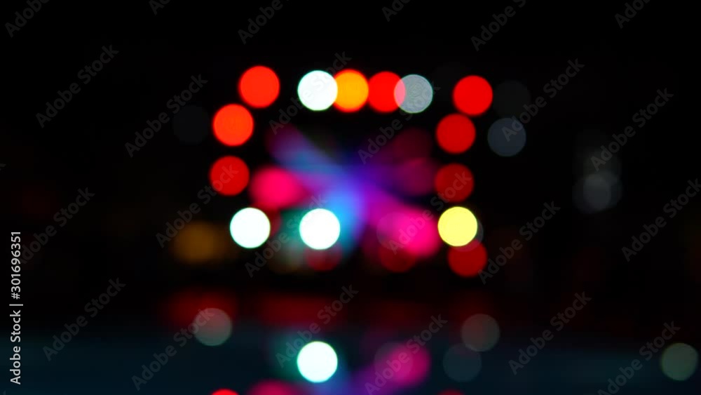 Blurred, defocused night pool party. Color lights reflections in the pool surface. Round bokeh. Beautiful background. Blurred, defocused night pool party. Color lights reflections in the pool surface. Round bokeh. Beautiful background.