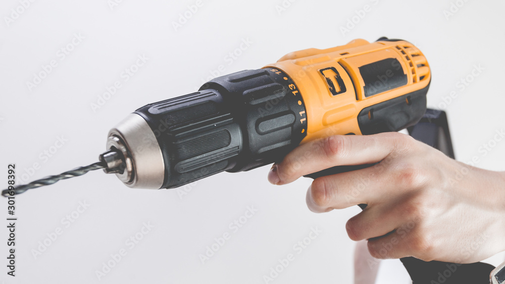 Hand holding yellow drill