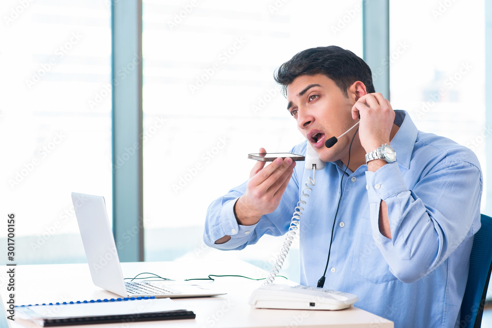 Male call-center operator in business concept Male call-center operator in business concept