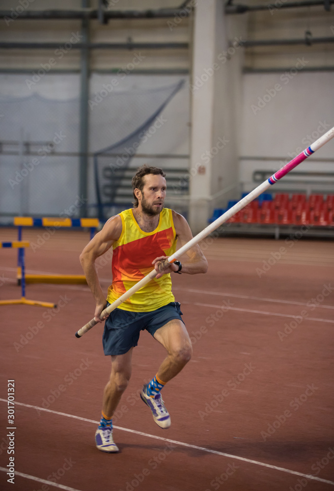 Pole vaulting - man is running with a pole in hands Pole vaulting - man is running with a pole in hands