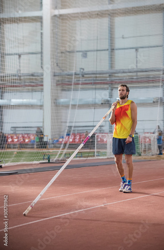 Pole vaulting - man with a beard is standing with a pole © KONSTANTIN SHISHKIN