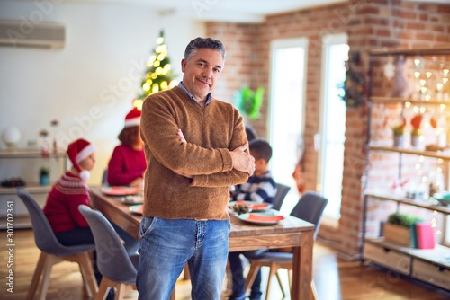 Middle age handsome man smiling happy and confident. Standing and posing celebrating christmas with family at home