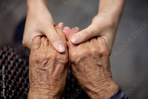 hands of old and young woman 