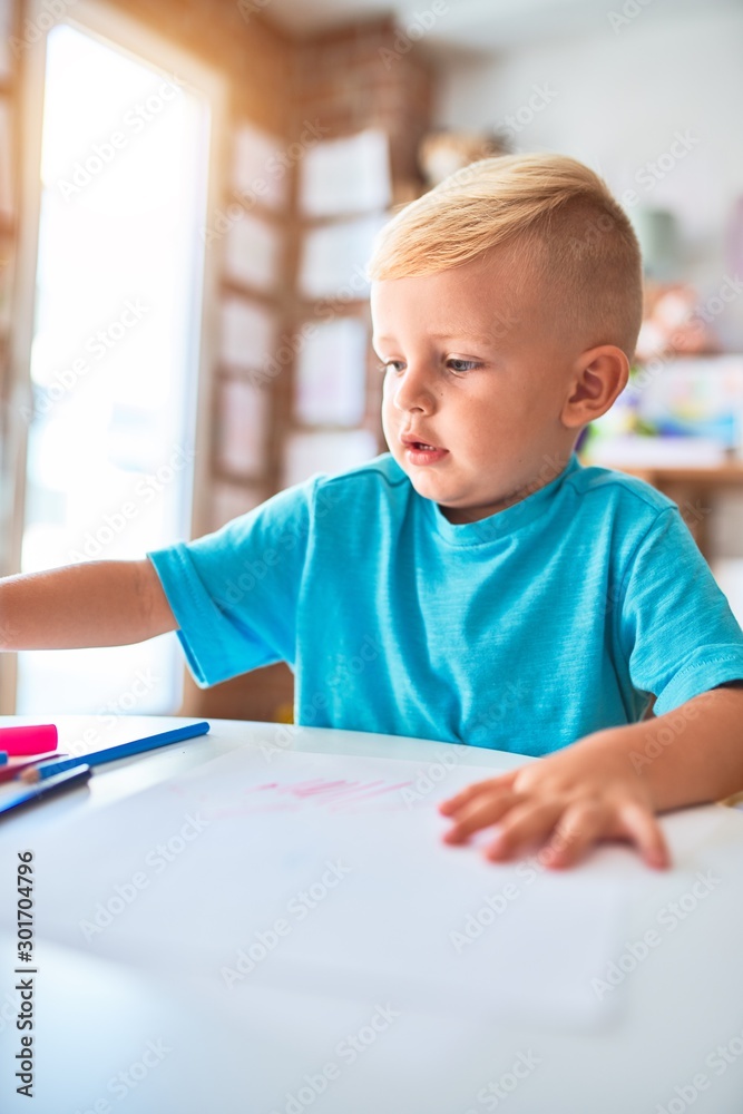 Young caucasian kid playing at kindergarten with toys. Preschooler boy happy at playroom. Young caucasian kid playing at kindergarten with toys. Preschooler boy happy at playroom.