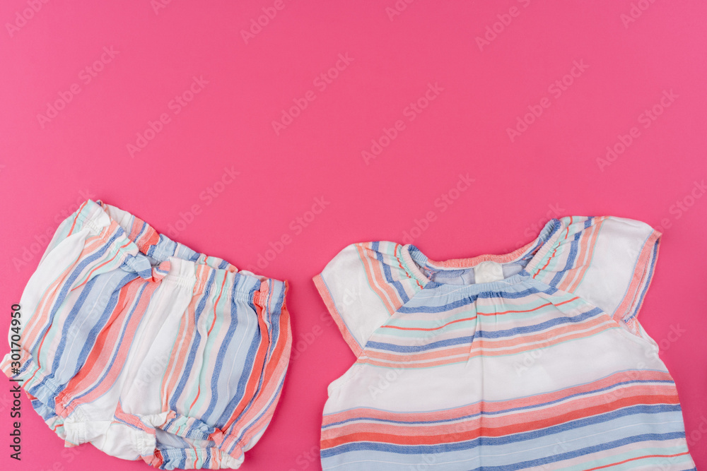 baby clothes on pink background top view baby clothes on pink background top view