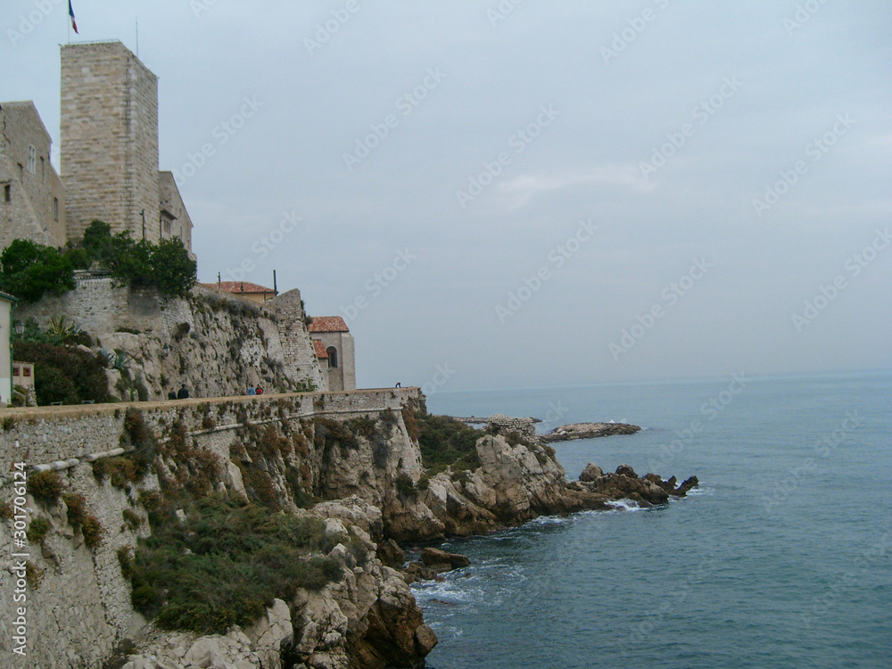 Rocky Coast streets of Antibes resort town. Cloudy day on French Riviera, France  