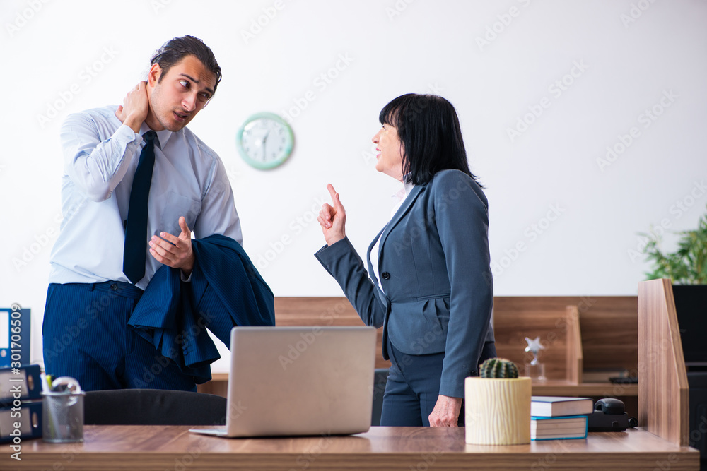 Two employees doing sport exercises in the office Two employees doing sport exercises in the office