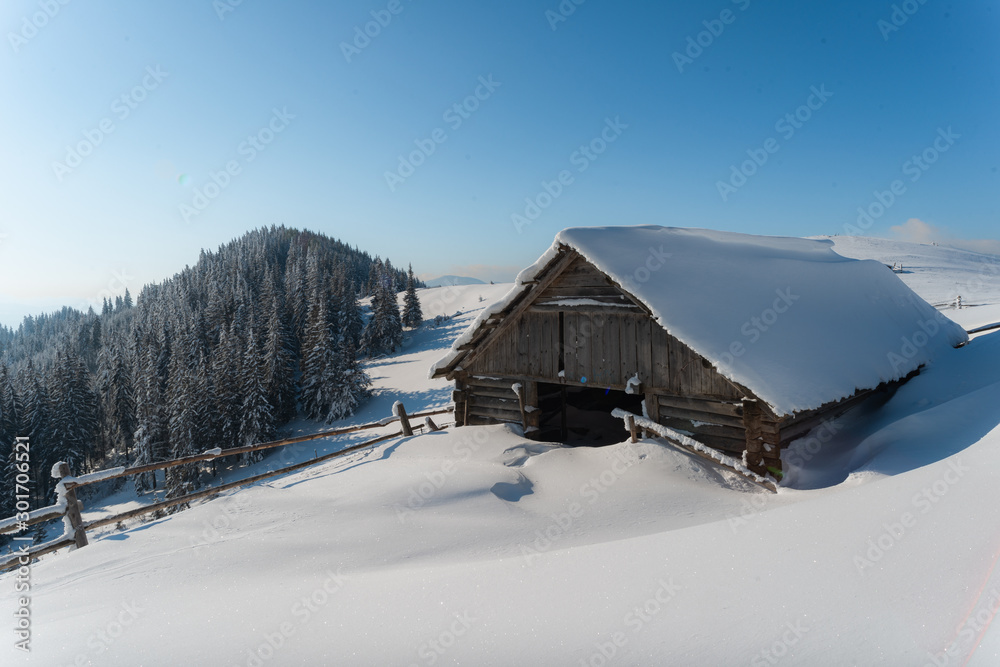Fantastic winter landscape with wooden house in snowy mountains. Christmas holiday concept. Carpathians mountain, Ukraine, Europe Fantastic winter landscape with wooden house in snowy mountains. Christmas holiday concept. Carpathians mountain, Ukraine, Europe