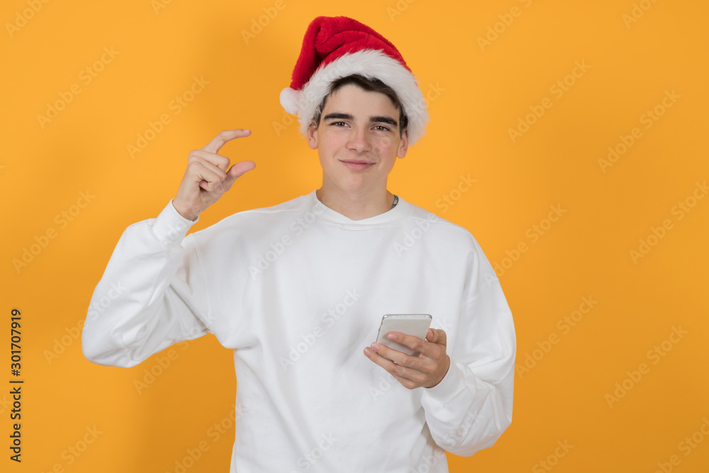 young man with santa claus hat isolated on color background young man with santa claus hat isolated on color background