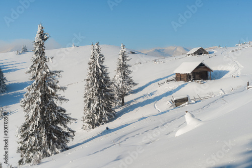 Fototapeta Naklejka Na Ścianę i Meble -  Beautiful pictures of nature in winter. Landscape with mountain huts in the snow.