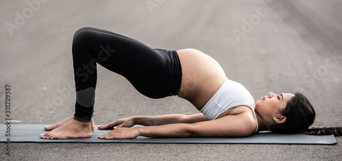 Pregnancy yoga woman doing yoga exercise in the morning for healthy and to keep body flexible