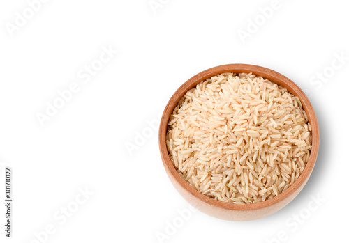 Brown jasmine rice or loonzain in wooden bowl isolated on white background with clipping path. Healthy food concept. Top view.Flat lay. photo