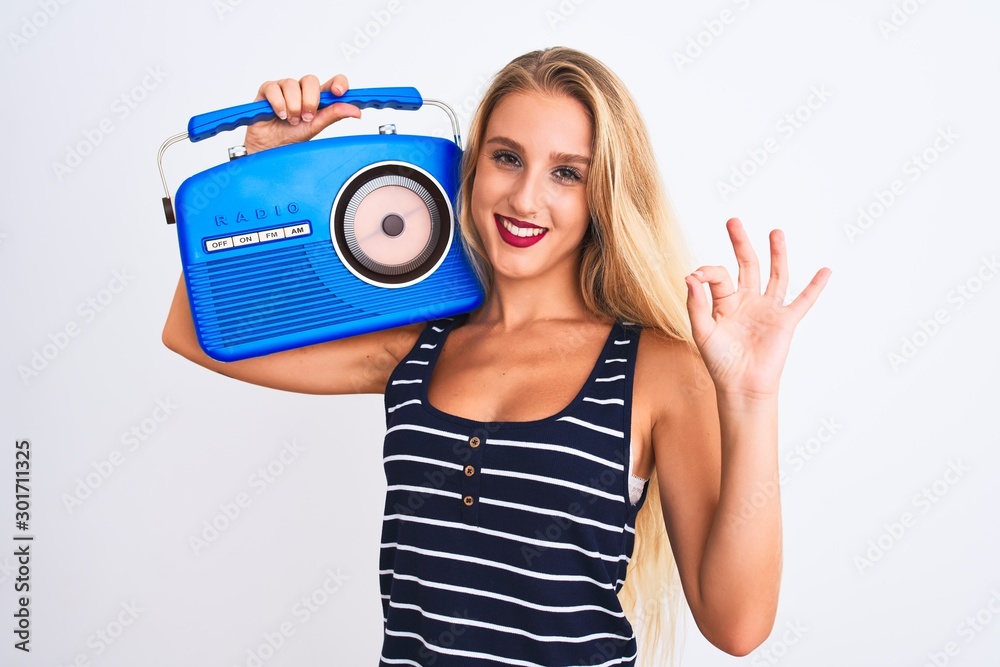 Young beautiful woman holding vintage radio standing over isolated white  background doing ok sign with fingers, excellent symbol Stock Photo | Adobe  Stock