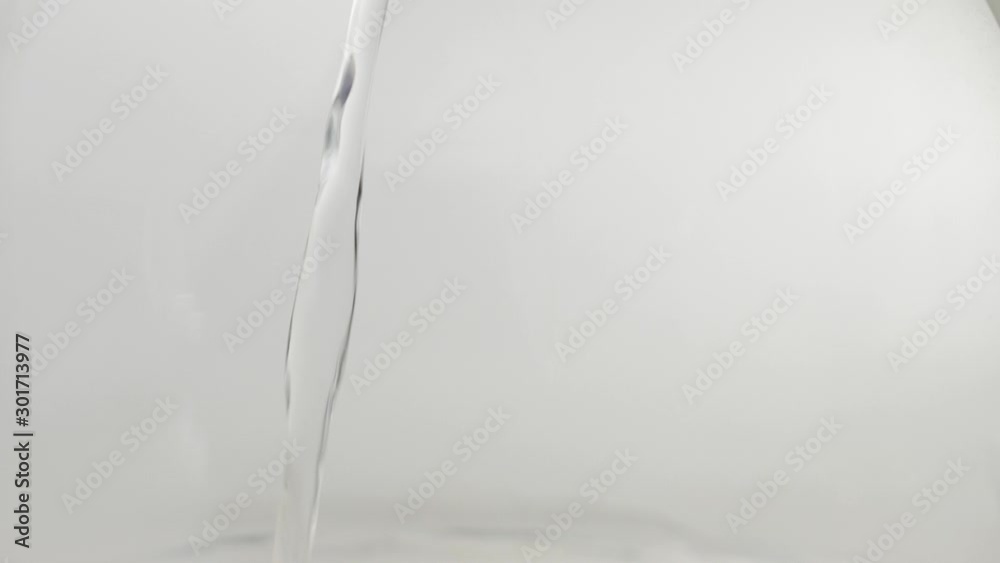 Boiling water is poured into a transparent pot on table against bright background. Modern cold Chinese ceremony. Close up. Side view Boiling water is poured into a transparent pot on table against bright background. Modern cold Chinese ceremony. Close up. Side view
