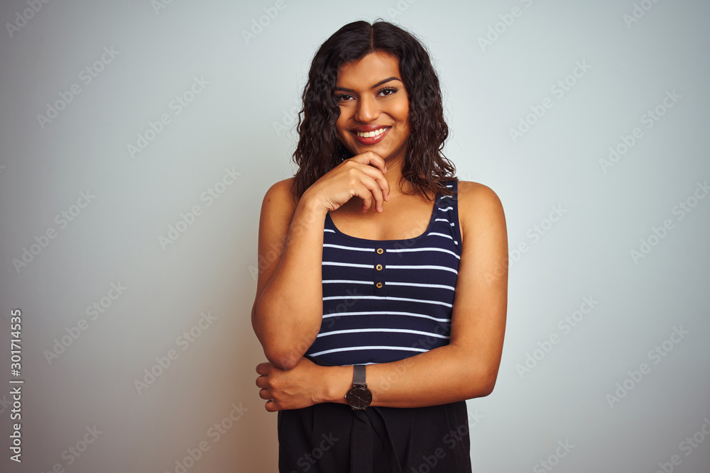 Transsexual transgender woman wearing striped t-shirt over isolated white background with hand on chin thinking about question, pensive expression. Smiling and thoughtful face. Doubt concept.