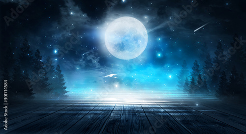 Empty dark background. The glow of the moon in the forest, moonlight through the trees in the forest. Wooden table top