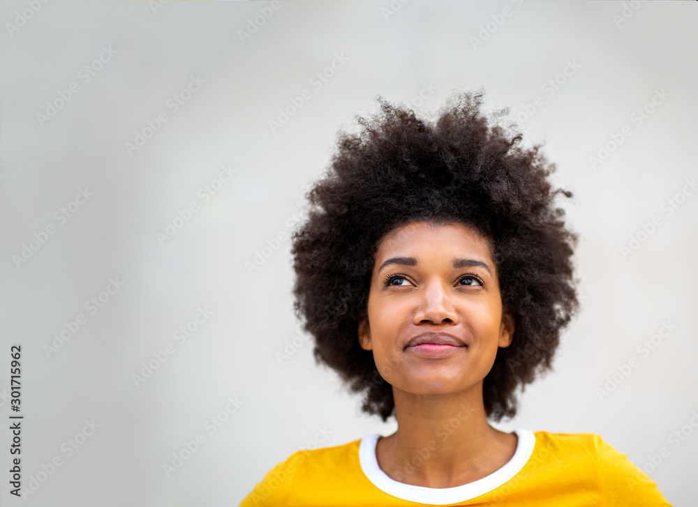 Close up of young black woman thinking and looking up Close up of young black woman thinking and looking up
