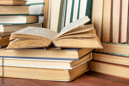 Open book on wood desk in the library room  for education background and back to school concept.