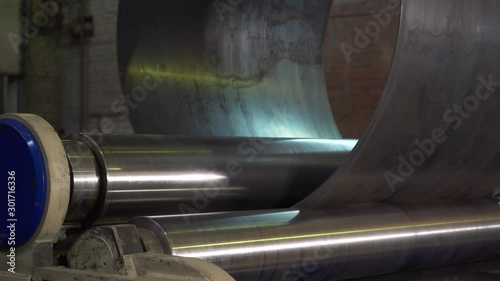In old production, huge machines twist metal into flat pipe, process before welding, preparation of processed metal, industry, metal rolling, export products, obsolete production, heavy machinery
