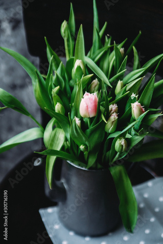  Pink and white tulips in a vase on the table