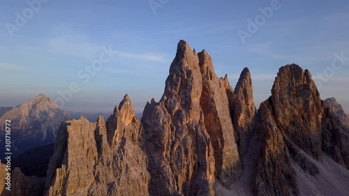 Spectacular last rays sunset from down to top drone aerial video to Croda da lago peaks in Dolomites area near Cortina D'Ampezzo, Italy. photo