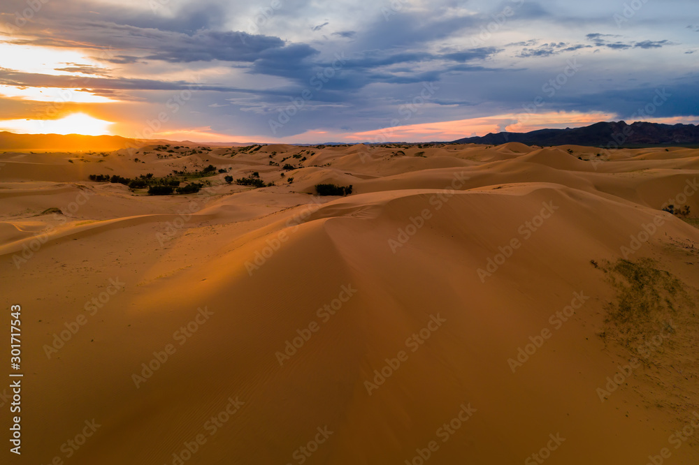 Sunset over the sand dunes in the desert