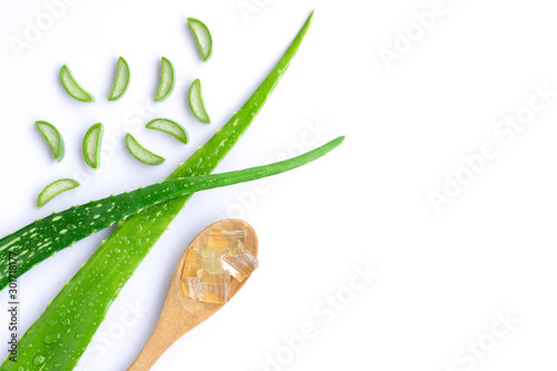 Green fresh aloe vera leaf with sliced and aloevera gel in wooden spoon isolated on white background.Natural herbal medical plant ,skincare ,healthcare and beauty spa concept. Top view. Flat lay. photo