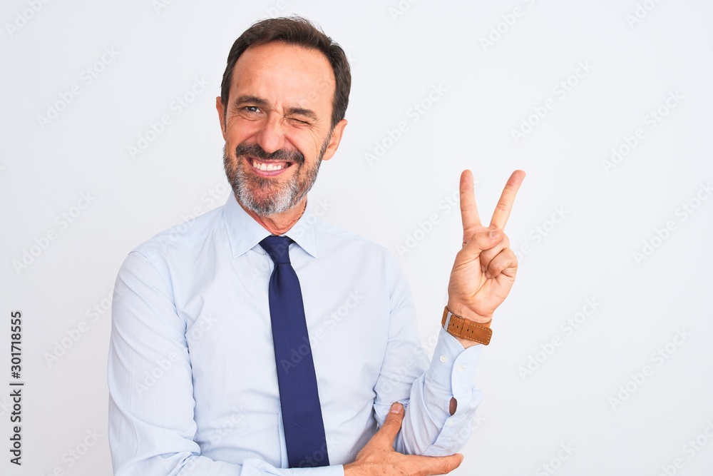 Middle age businessman wearing elegant tie standing over isolated white background smiling with happy face winking at the camera doing victory sign. Number two. Middle age businessman wearing elegant tie standing over isolated white background smiling with happy face winking at the camera doing victory sign. Number two.