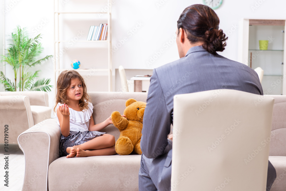 Child psychologist attending small girl Child psychologist attending small girl