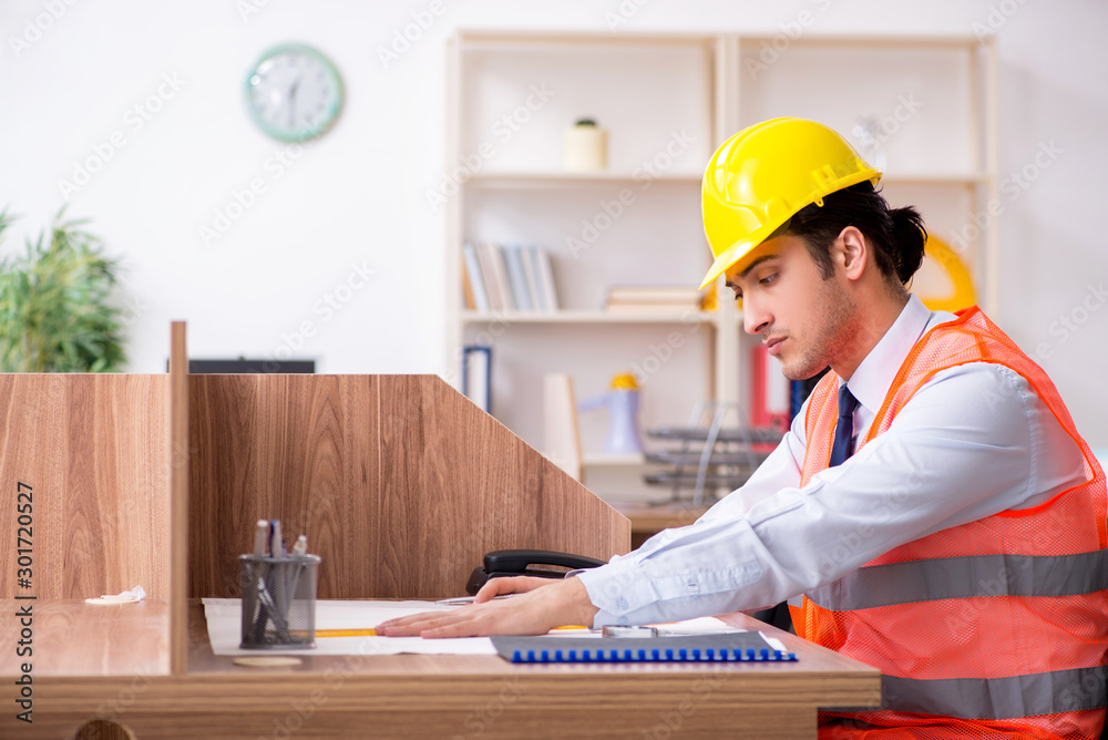 Young male architect working in the office