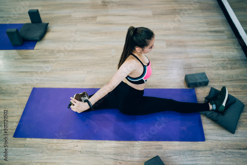 Woman stretching on gym mat