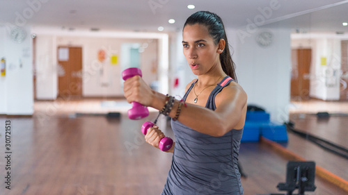 beautiful latin woman in the gym photo