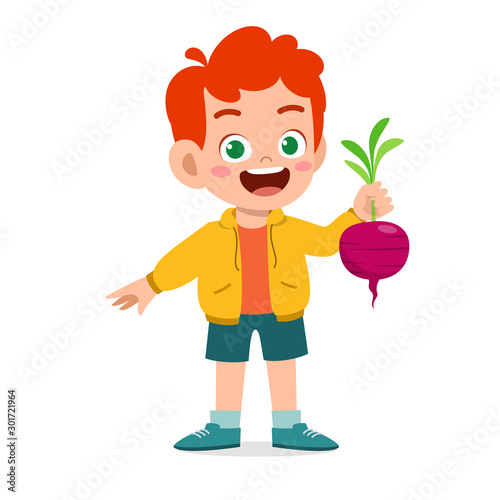 happy cute kid boy holding fresh vegetable