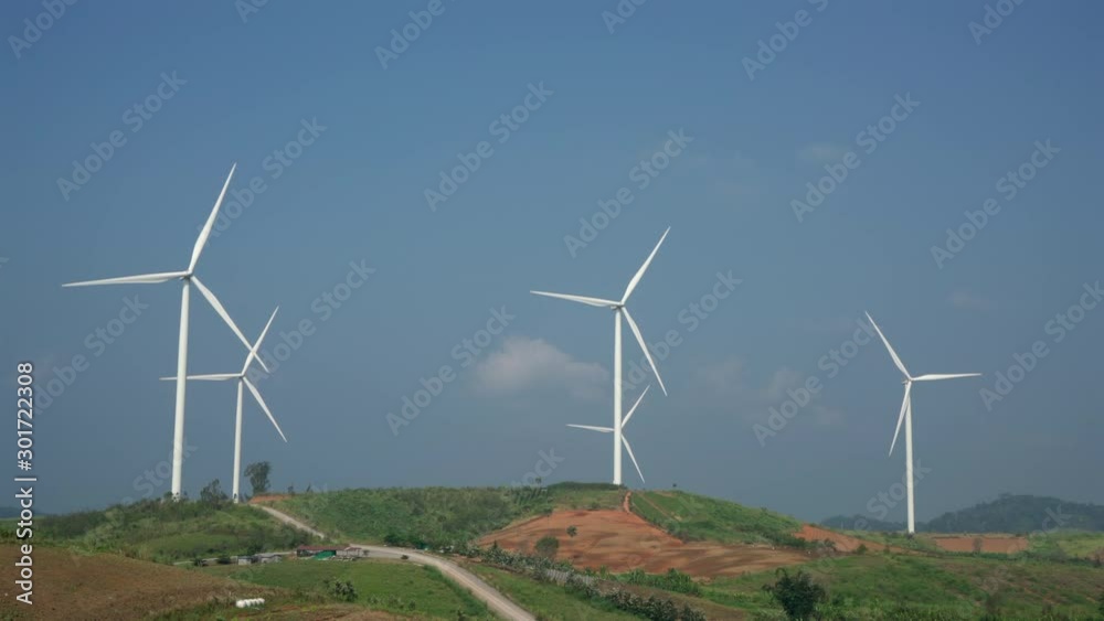 Wind turbines in agricultural fields on blue sky background, Wind Turbine producing alternative energy. Ecology and nature conservation Wind turbines in agricultural fields on blue sky background, Wind Turbine producing alternative energy. Ecology and nature conservation
