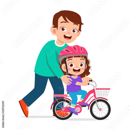happy cute kid girl riding bike with dad