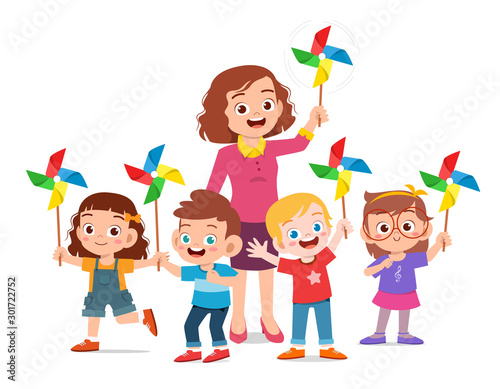 happy cute kids and teacher holding toy