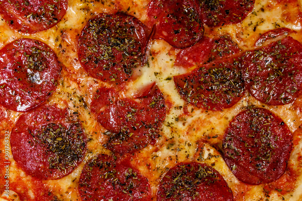 Texture of a delicious fresh pizza with sausage and cheese Texture of a delicious fresh pizza with sausage and cheese