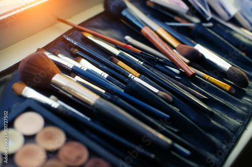 Set of brushes for professional makeup in special black case, close-up. A variety of brushes and applicators, make-up artist tool. © exebiche