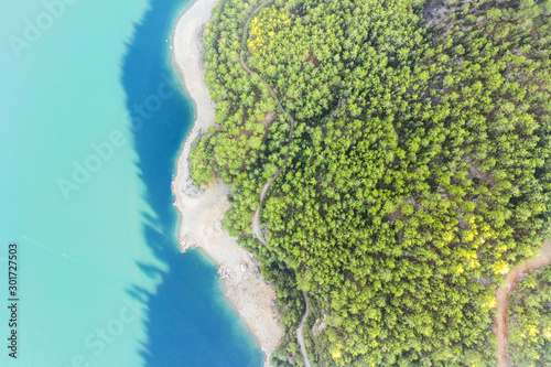 An aerial view of Lake and Forest with a narrow path © Sondem