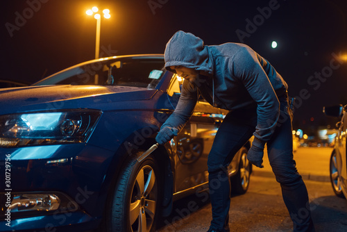 Car robber punctures the tyre, vandalism, hooligan © Nomad_Soul