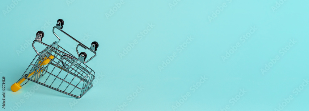 Εκτύπωση καμβά Empty inverted shopping cart on blue background