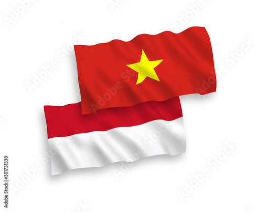 National vector fabric wave flags of Indonesia and Vietnam isolated on white background. 1 to 2 proportion.