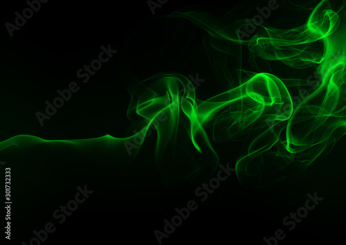 Green smoke abstract on a black background, darkness concept