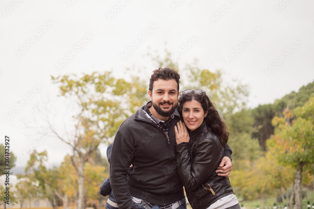 Fototapeta premium 30-40 years old Couple in park posing for a photo
